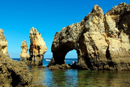 Lagos: Viewpoints over a deep blue sea dotted with rocks that point to at the sky.